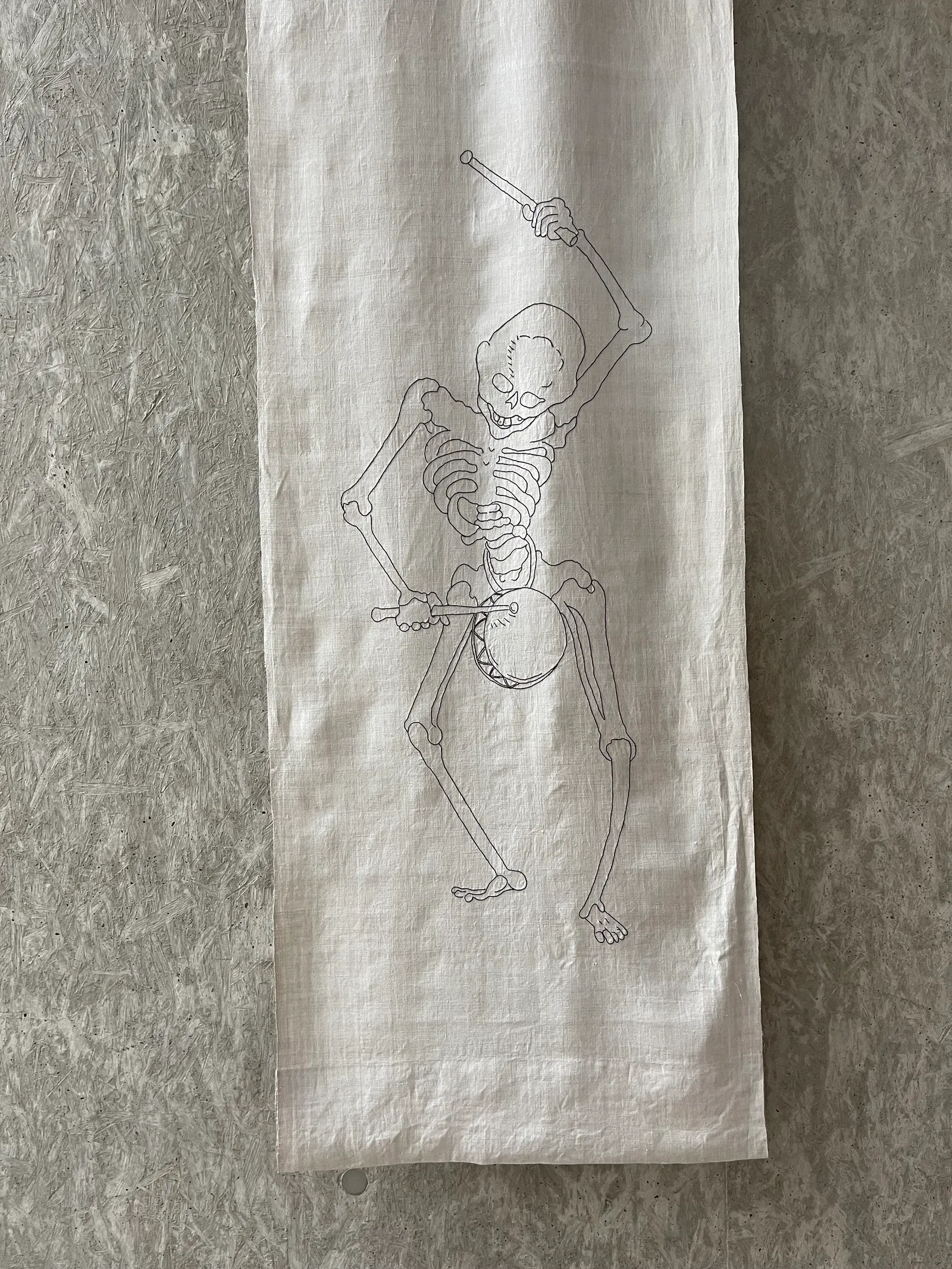 Embroidered linen strip lying flat