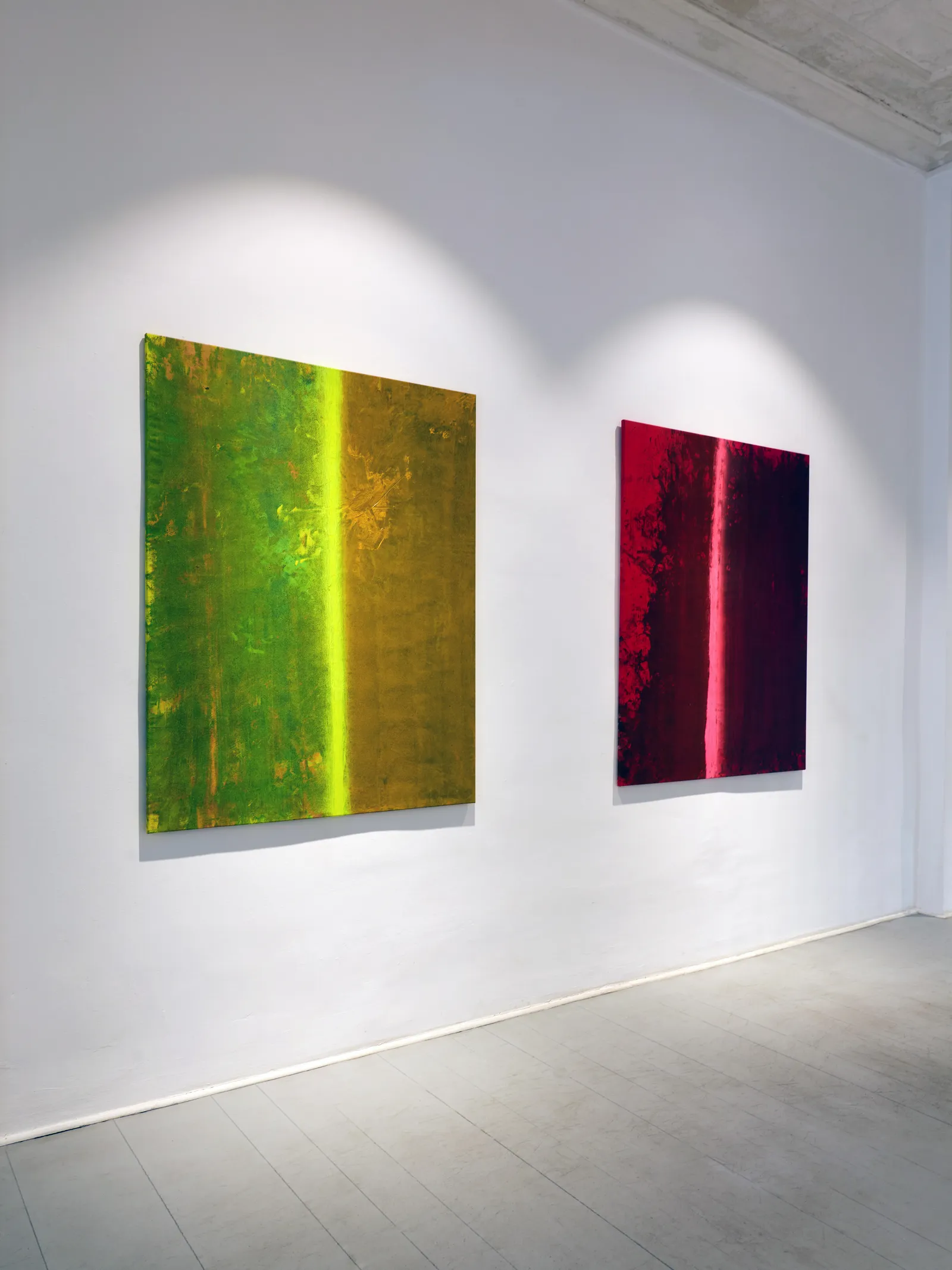 Green and red paintings by FH Fischer installed in the gallery